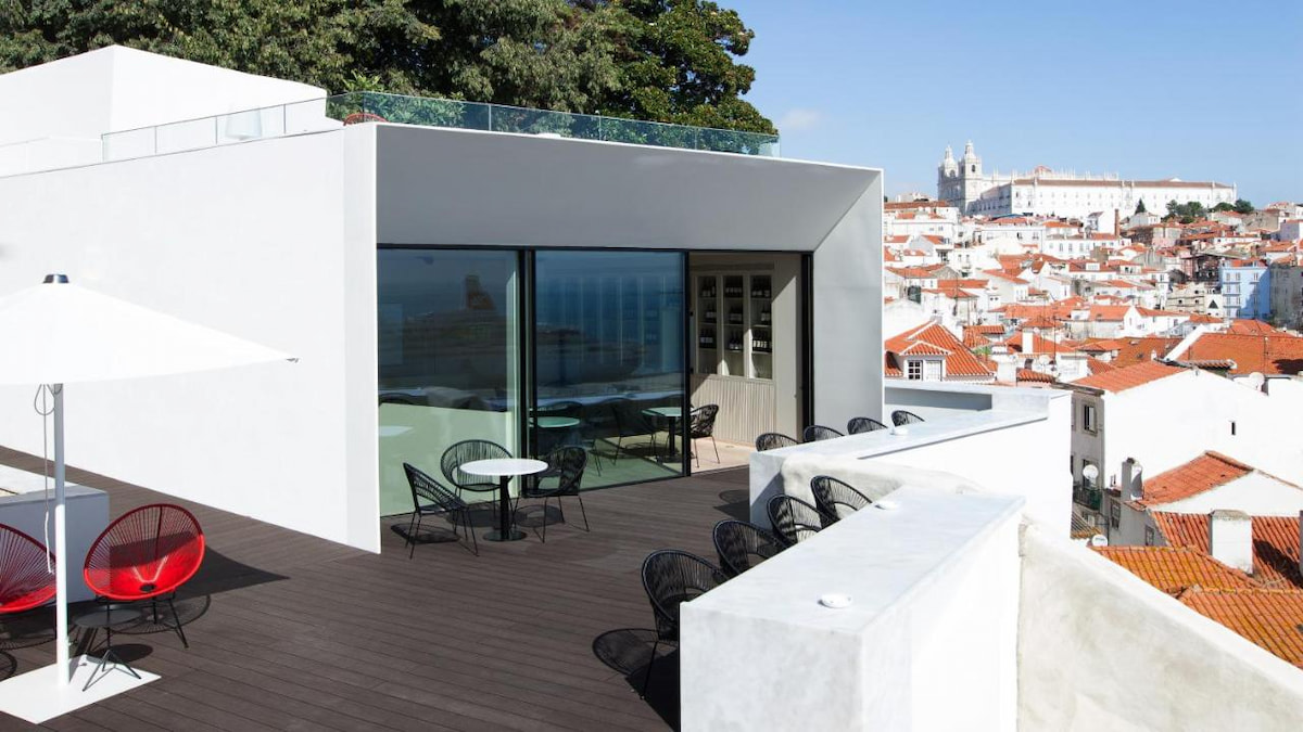 white modern hotel balcony overlooking Lisbon neighbourhood Alfama