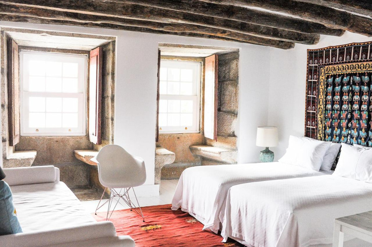 cave like hotel suite with double bed and red carpet is where to stay in Porto