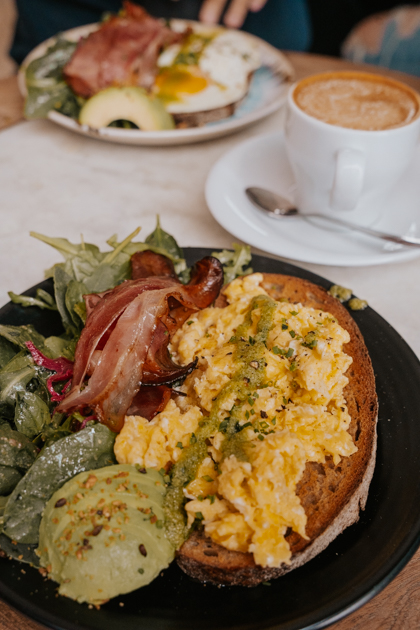 a close up of eggs and avocado toast with Bacon fueling a 24 hours in Lisbon experience