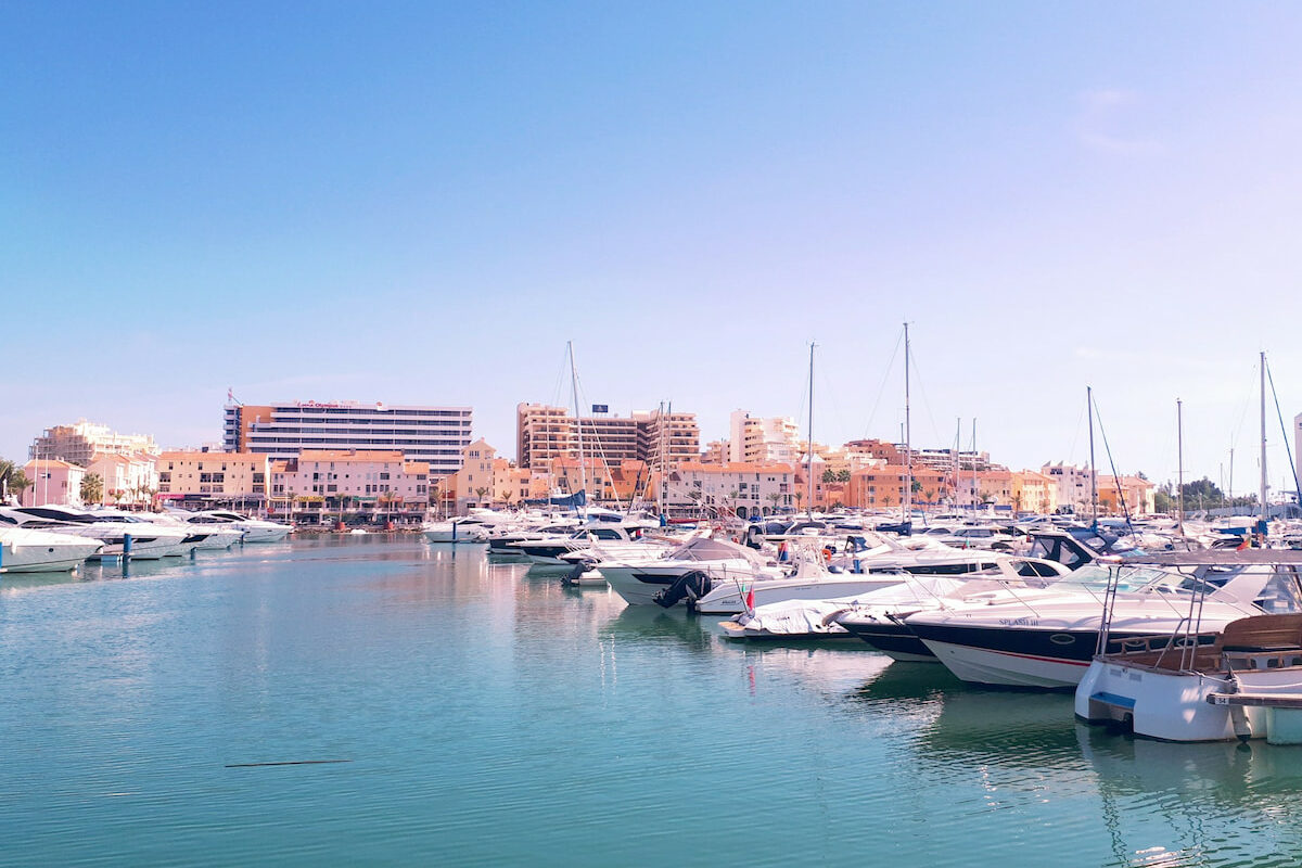 Vilamoura Algarve harbour with boats and buildings in the distance at dusk where to stay in Algarve for luxury