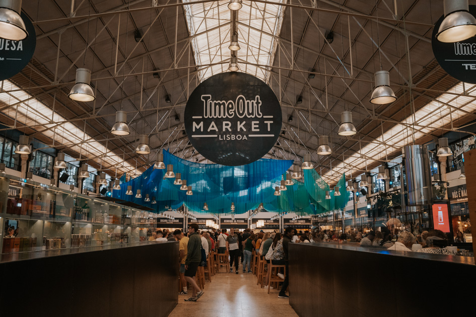 inside of a large food market with a sign that reads 'Time Out Market Lisboa' is one of the top things to do Lisbon