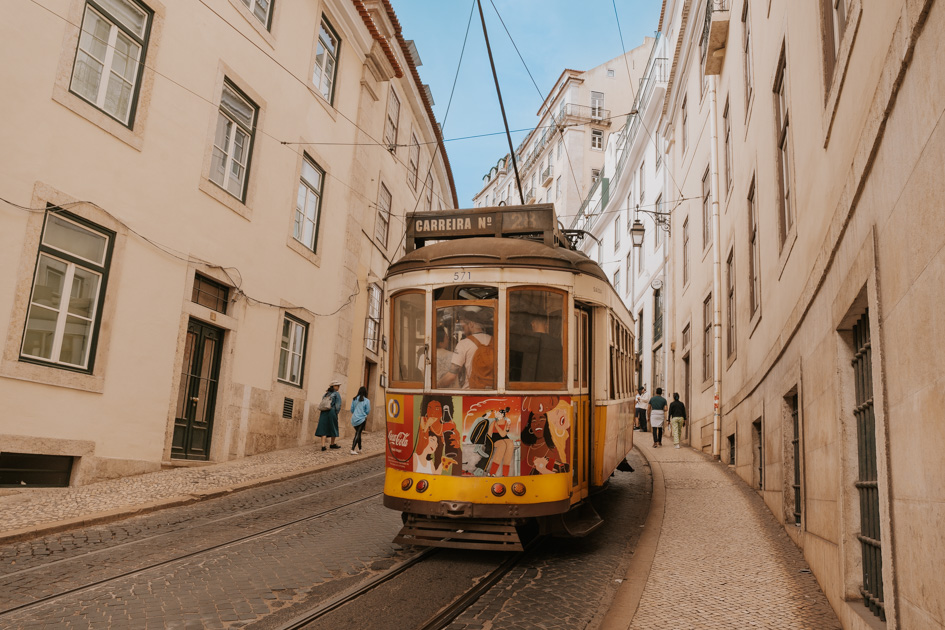 the famous Tram 28 runs down a track in Baixa Lisbon activities