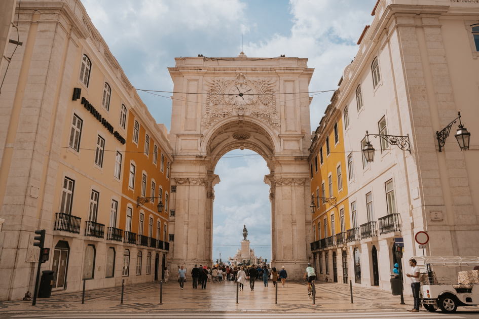 Looking out at the historic white stone arch in front of the Placa do Comercio in central Lisbon