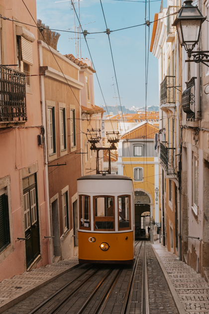 famous yellow tram runs along a track up the Lisbon Hills