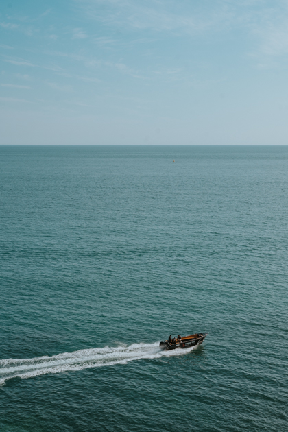 a speedboat zooms through the Atlantic Ocean off the coast of Algarve's best town