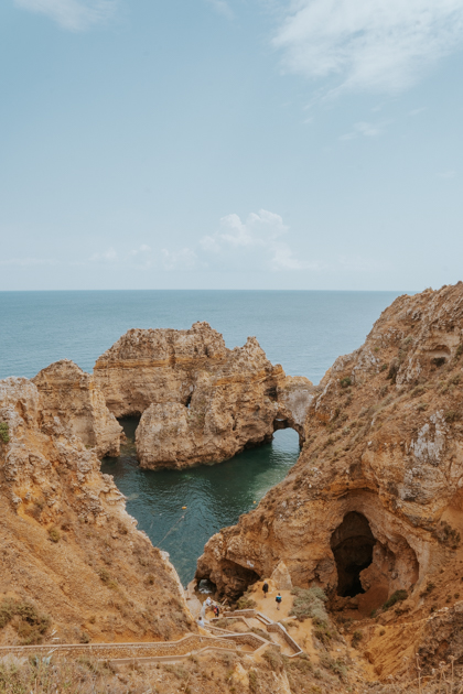 rugged rock formations sit off the coastline of Lagos on a sunny day in Algarve Portugal towns