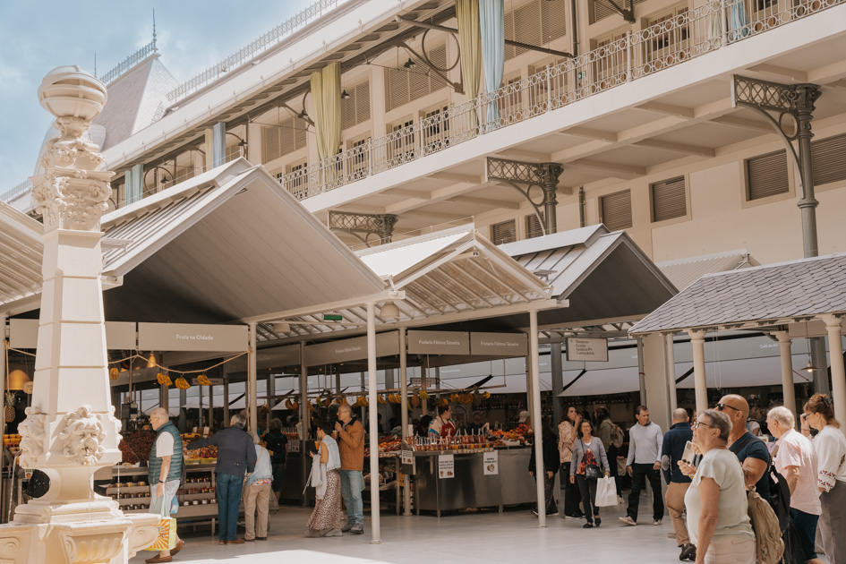 outdoor market with modern peaked tin roofs and tourists roaming around in Bonfim, where to stay in Porto Portugal for foodies